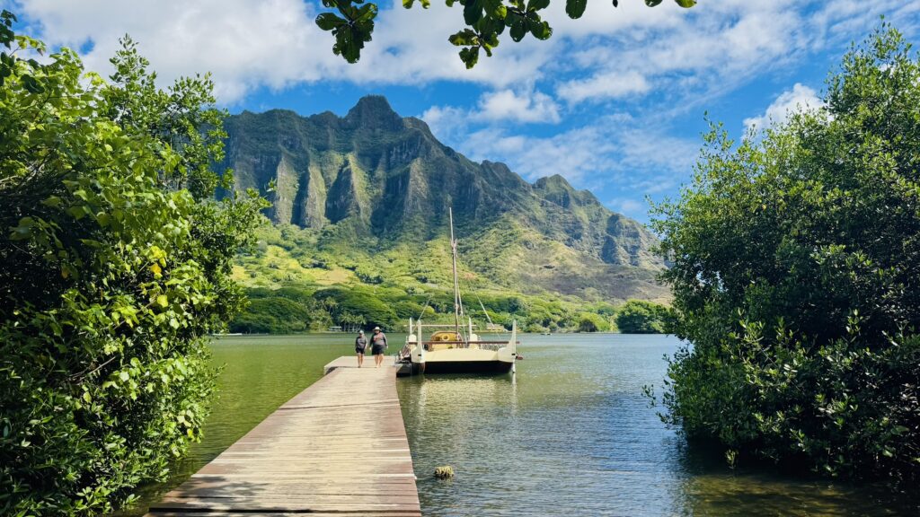 Scenic view of Kualoa Ranch on Oahu, Hawaii featuring lush green mountains and tropical landscapes